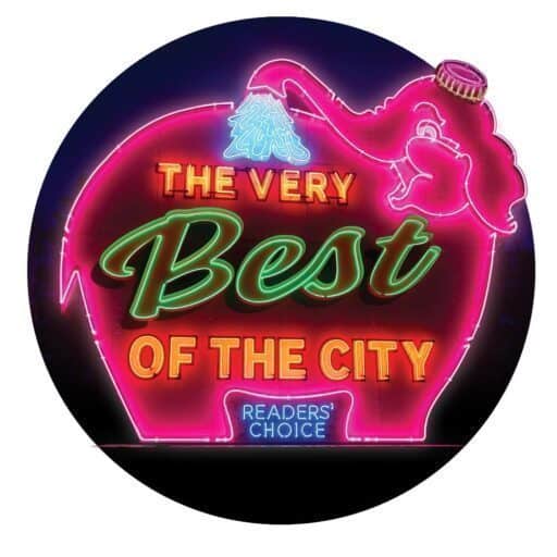 A neon sign shaped like an elephant with text reading "The Very Best of the City" and "Readers' Choice.