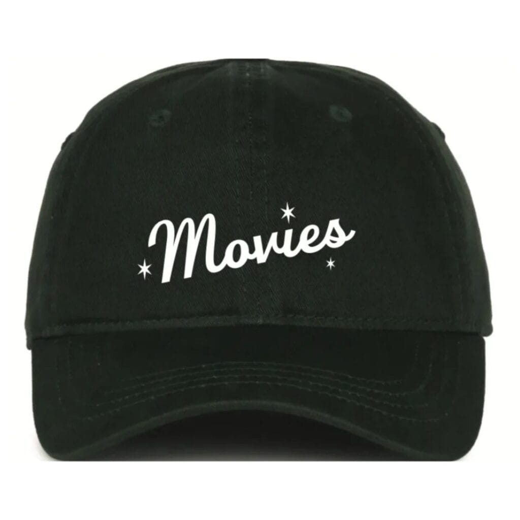 A black baseball cap with the word "Movies" and three small stars printed in white on the front.