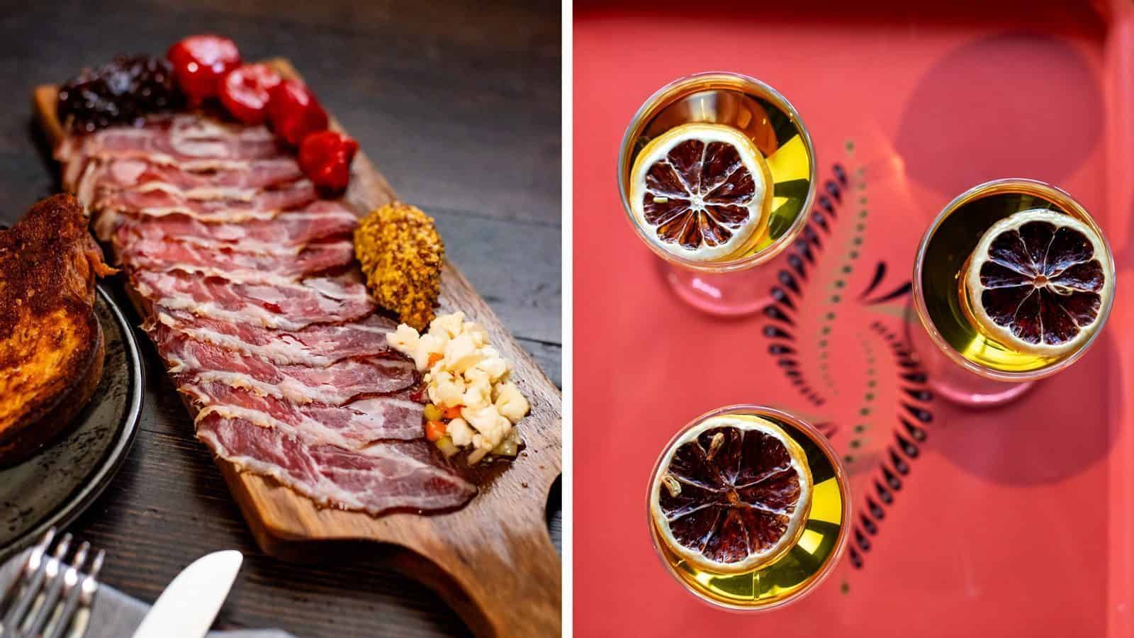 A wooden board with sliced cured meat, mustard, pickles, and garnish on the left, and three glasses of cocktails with dried citrus garnishes on a red tray on the right presents a taste of Hidden Washington. Perfectly crafted delights close to Bothell await you.