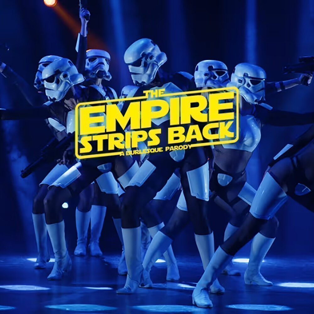 Performers dressed as Stormtroopers pose on stage under blue lighting, with the text "The Empire Strips Back: A Burlesque Parody" in bold yellow letters. Catch this Must List show on 07-03-2025!.